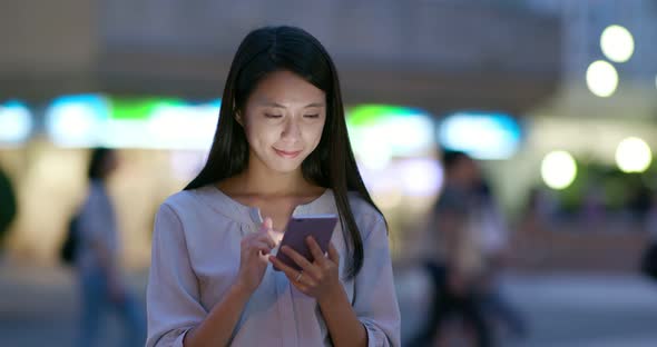 Woman use of mobile phone at night