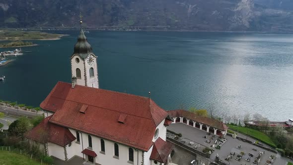 Aerial video of the Fluelen church in the Uri Canton of Switzerland during spring (2)