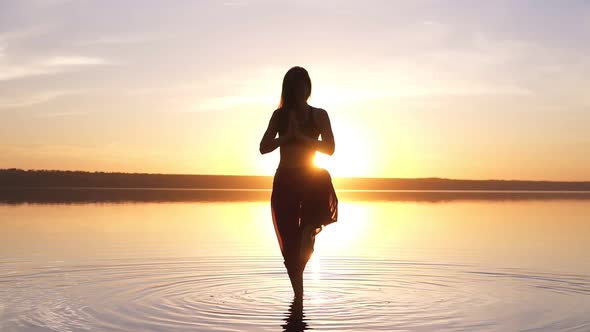 Beautiful Footage on Sunset Beach Woman Doing Yoga Asana Utthita Hasta Padagushthasana Staying in