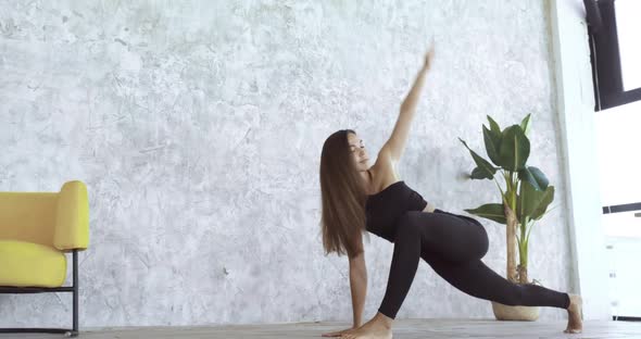 Teen Beautiful Lady Woman Goes in for Sports at Home, Stands in Asana Pose, Stretches Thigh Legs