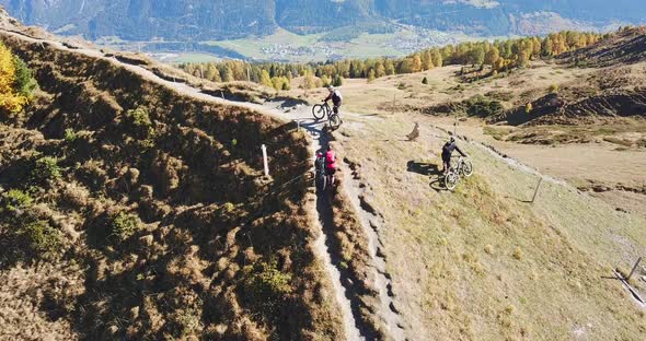 Aerial drone view of a group of mountain bikers on a singletrack trail.