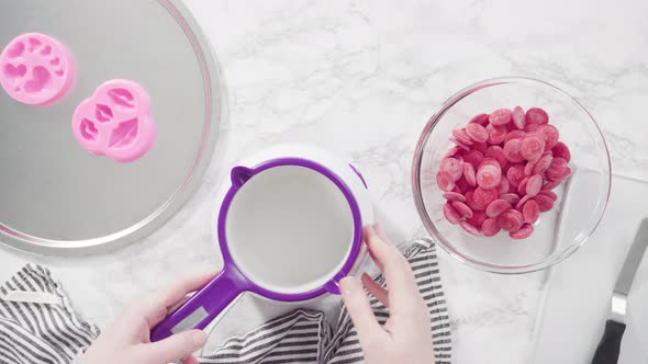 Flat lay. Flat lay. Melting red chocolate melts in the candy melting pot.