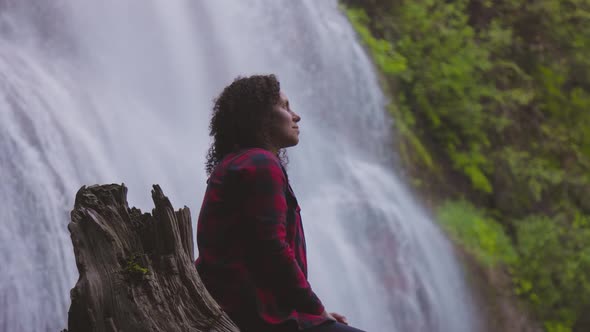 Woman Watching the Waterfall in the Canadian Rainforest