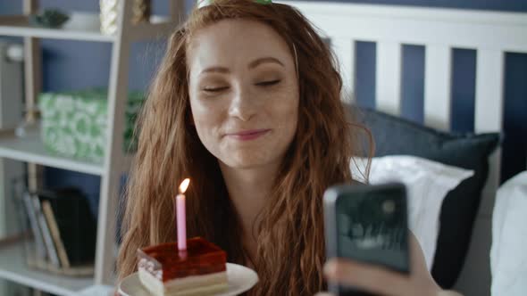 Video of woman taking a selfie with birthday cake