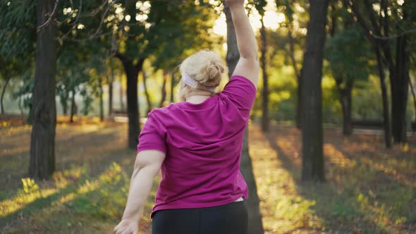 Back View of Overweight Woman Doing Exercises