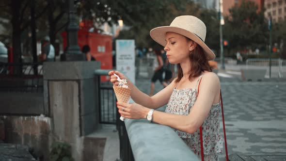 Young girl eating ice cream in a park