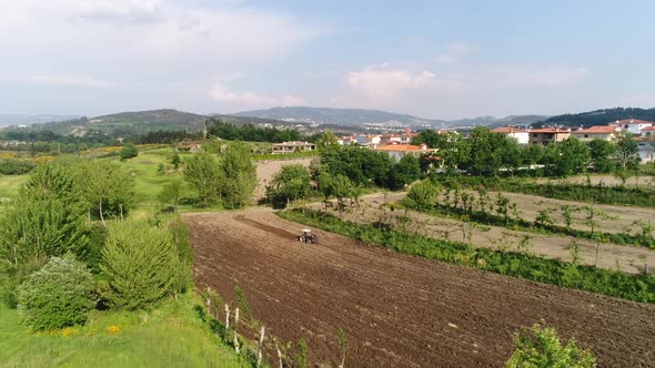 Tractor Driver on Tractor Plows Land