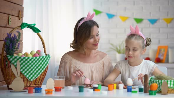 Little Daughter Kissing Mother on Cheek Helping With Easter Eggs Decor, Love