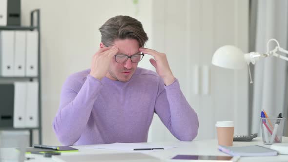 Middle Aged Man Having Headache in Office