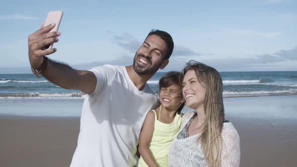 Joyful Parents and Little Daughter Taking Selfie on Phone