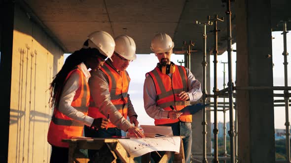 People in Uniform Work Together on a Building Site.