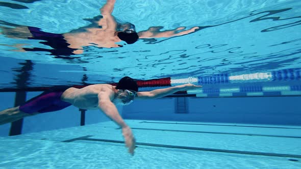 Male Athlete Swimming Underwater in a Close Up