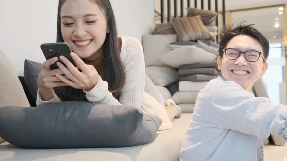 asian marry sweet romance couple family both enjoy pravate technology smartphone