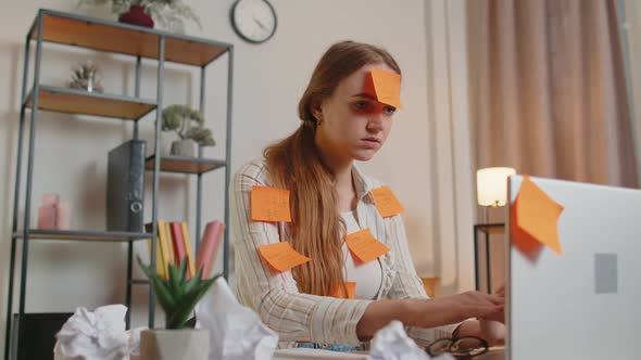 Exhausted Woman Freelancer with Pasted Stickers Using Laptop Having Concentration Problem in Office