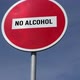 red road sign no entry with text No Alcohol against the blue sky background - VideoHive Item for Sale