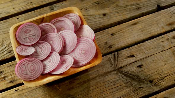 Sliced onions in wooden bowl 4k