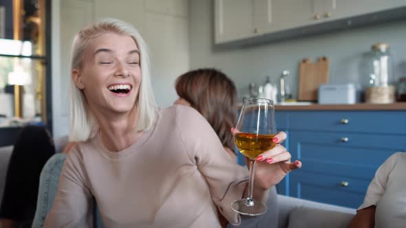 Blonde adult girl talking with friends at the house party. Shot with RED helium camera in 8K