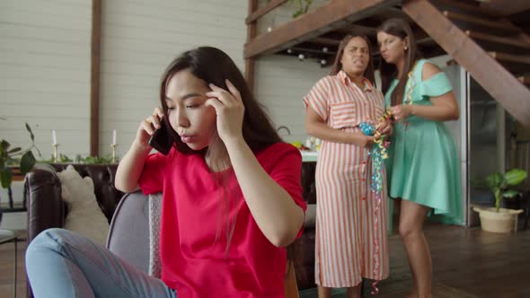 Portrait of Young Irritated Woman Arguing Using Mobile Phone Indoors