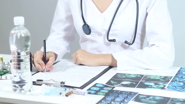 Doctor Fills In The Medical Form In The Hospital