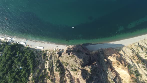 Aerial View From Above on Calm Azure Sea and Volcanic Rocky Shores