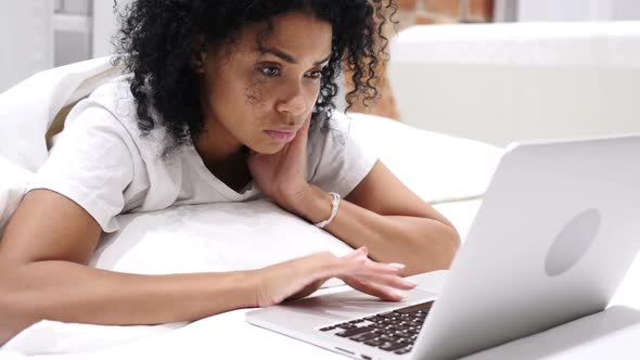 Headache Frustrated AfroAmerican Woman Working on Laptop in Bed