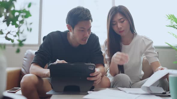 asian marry couple checking and calculate financial billing together