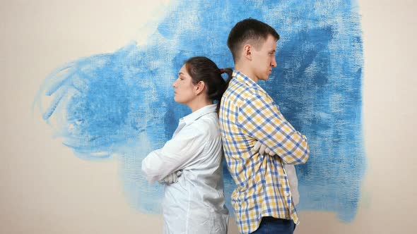 Sad Brunette Stands with Crossed Hands and Back to Guy