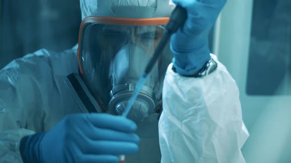 One Man Uses Pipette and Tube While Developing a Coronavirus Vaccine.