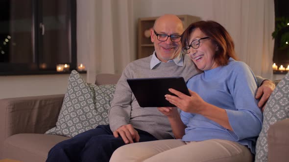Happy Senior Couple with Tablet Pc at Home