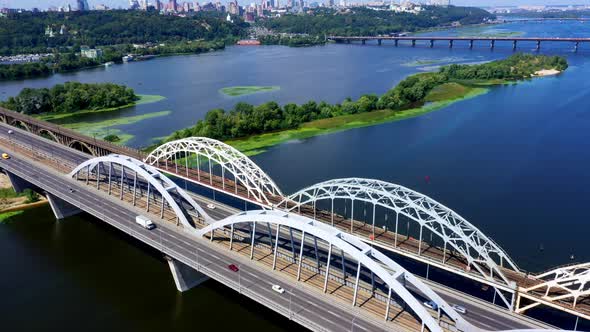 Panoraming Shot of the Railroad Bridge Across the River Dnipro in Kyiv in the Afternoon Sunny Day