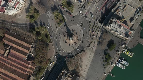 AERIAL: Overhead Shot of Columbus Monument Roundabout in Barcelona, Spain with Busy Car Traffic on