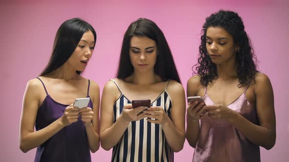 Girls With Smartphones Looking Female Friend Texting Message, Pink Background