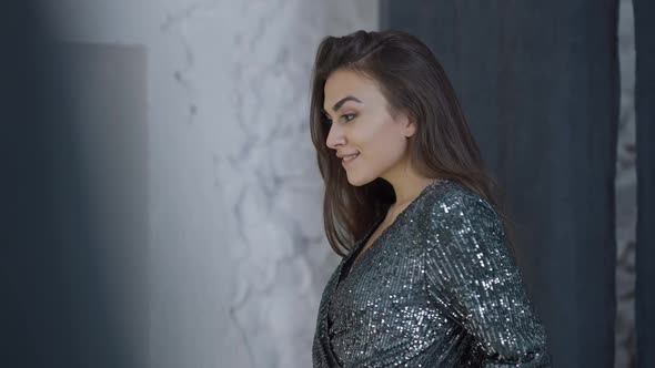 Gorgeous Slim Wealthy Rich Woman Admiring New Sparkling Black Dress in Dressing Room in Shop