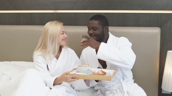 Adorable Multiethnic Couple Have Breakfast in Hotel