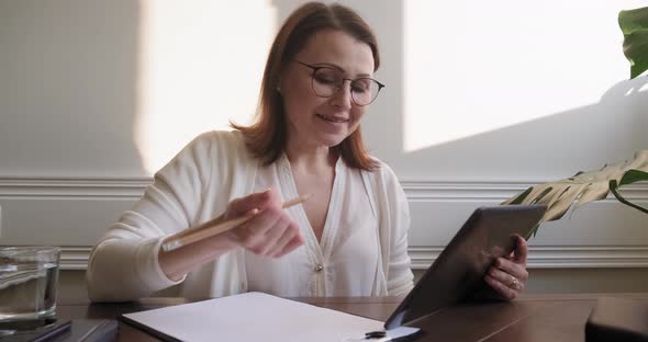 Female Psychologist, Psychiatrist Looking at Webcam of Digital Tablet