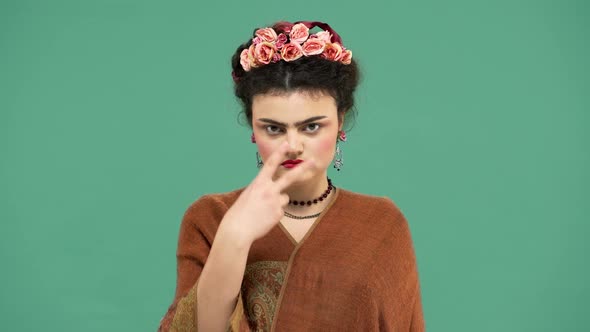 Portrait of Woman with Thick Eyebrows and Red Lips Makeup As Frida Kahlo Wearing Roses in Hair and