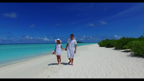 Man and woman relax on beautiful shore beach journey by blue ocean with bright sand background of th