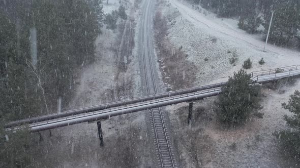 AERIAL: Sad Overpass Bridge over the Railway During Blizzard 