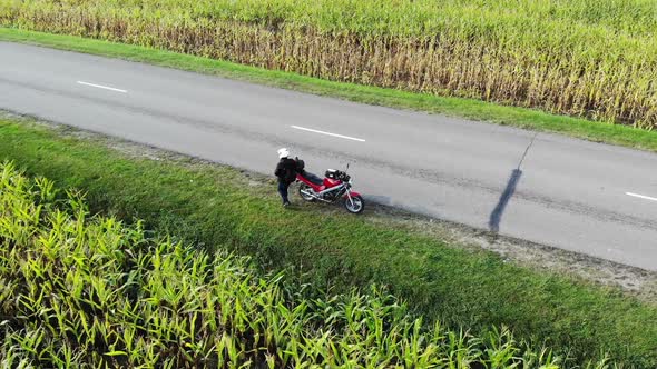 Motorcycle Riding By Country Road on Sunset, Beautiful Adventure Travel Footage Shot From Drone, Top