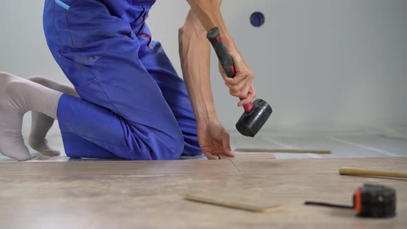 A Man Professional Laminate Installer Laying Laminate Wood