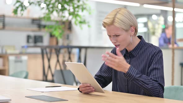 Disappointed Businesswoman Having Loss on Digital Tablet in Office 