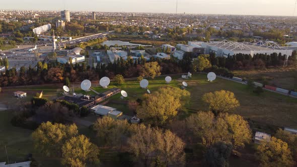 Aerial view showing many white circular antennas in research center of Buenos Aires during sunset