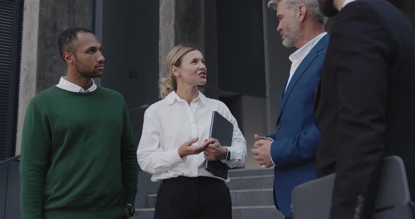 Diverse Colleagues Having Conversation Near Office On Street