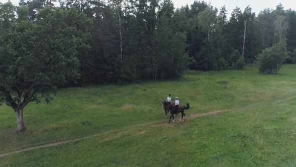 Family Outdoor Recreation Man Cowboy and a Woman Riding a Horse in a Clearing Near the Forest View