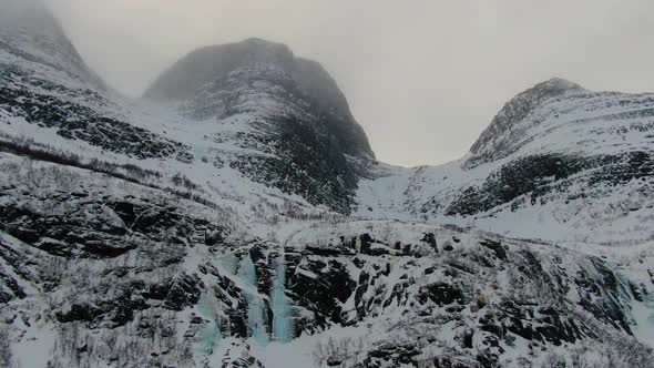 Aerial view of a mountain in Lyngen Alps with frozen waterfalls, Norway, Arctic