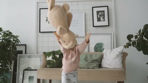 Little Girl Throws Up Plush Rabbit