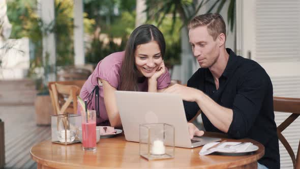 Business Partners, Woman and Man Work in Cafe, Use Laptop, Discuss Project