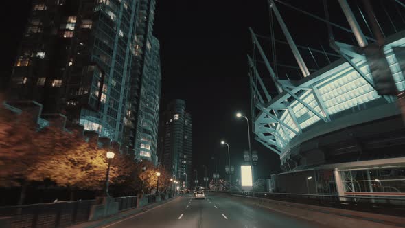 Wide smooth shot of a Vancouver downtown Night road near stadium, Canada