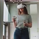 Young woman wearing vr goggles with control handles in hands - VideoHive Item for Sale