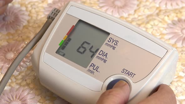 A Man Uses a Device To Measure Heart Pressure. A Man Pressed Measure Pressure Using a Tonometer